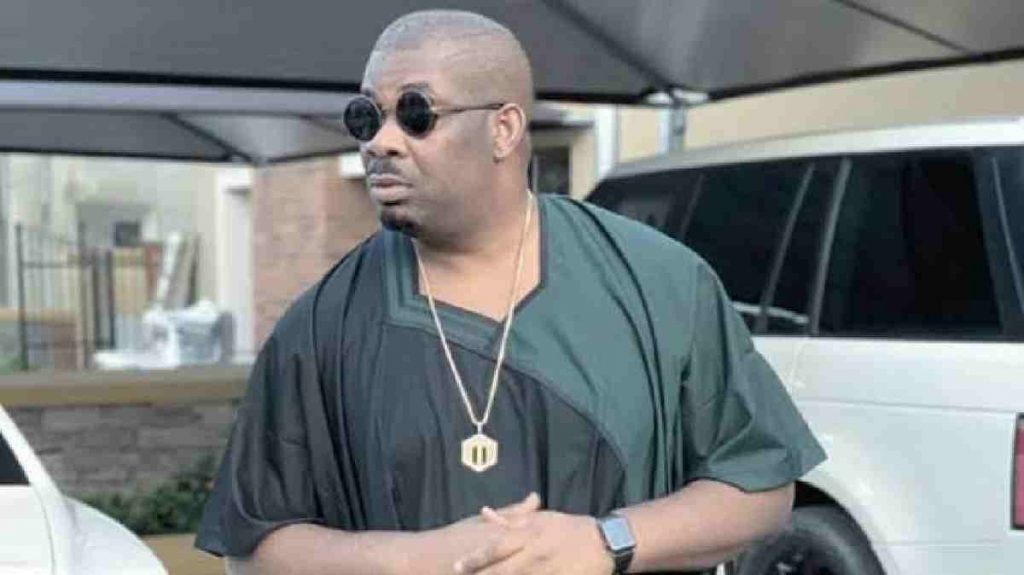 Image of Don Jazzy standing close to his Car