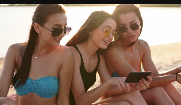 Three girls on their phones chatting on a forum